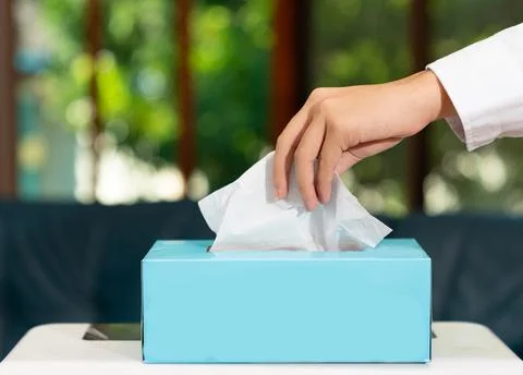 The man hand pulling a tissue box. Stock Photos