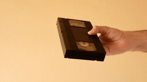 Man hand pulls out of the box a VHS video tape cassette Stock Footage 107429805
