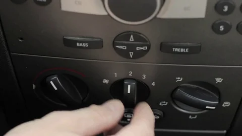 Man hand pushes the car climate control button. Regulator temperature cold and Stock Footage 79778971