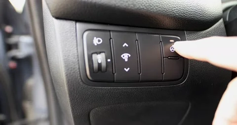 A man hand pushes the heated steering wheel button on a car.  Close up Stock Footage 89408021