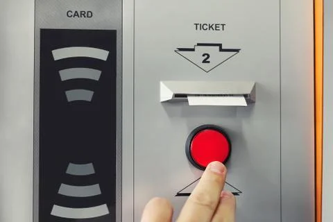Man hand pushing red button to recieve ticket at car parking entrance. Ticket Stock-Fotos