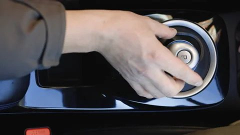 Man hand pushing reverse gear button in car. Driver's adm includes mode Reverse Stock Footage 196001908