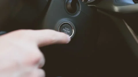 Man hand pushing Start Stop engine button in the car Stock Footage 150750053