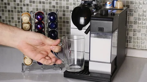 Man Hand Put Capsule in Espresso Coffee Maker Machine and Press the Start Button Stock Footage 124573934