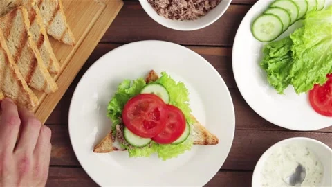 Man hand put grilled bread on tuna sandwich top view.prepare healthy snack Stock Footage 111824448