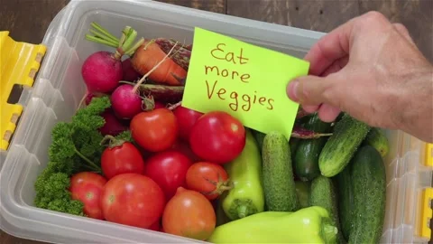Man hand put paper sticker to food container with fresh vegetables Stock Footage 120496592