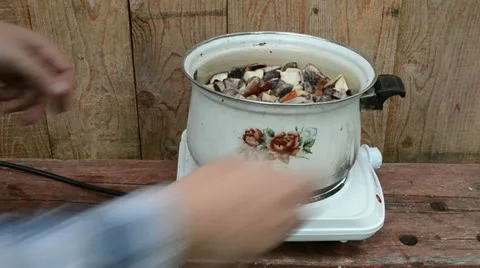Man hand put pot with mushrooms for boiling Stock Footage