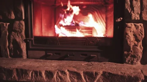 Man Hand puts Winter Boots on a Shelf near Cozy Burning Fireplace. 4K. Stock-Footage 67848440