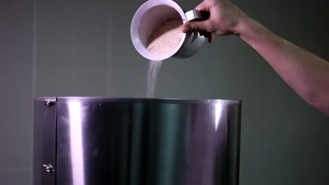 Man hand putting carefully a small amount of brown sugar from cup in automatic p Stock Footage 137541679