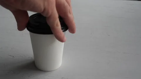Man hand putting coffee to go on the table. Coffee Video stock 143255184