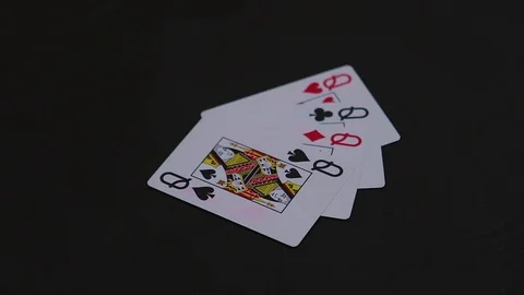 Man hand putting four queen poker cards on the black table Stock-Footage 77041861