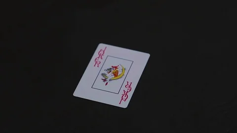 Man hand putting joker poker card on the black table Video stock 77041853