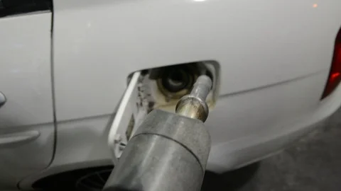 Man hand refueling car. Close up shot of insertion of the nozzle and pumping gas 動画素材 119380460
