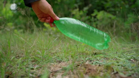 Man hand remove plastic bottle from meadow. Save and rescue our planet Stock Footage 158119949