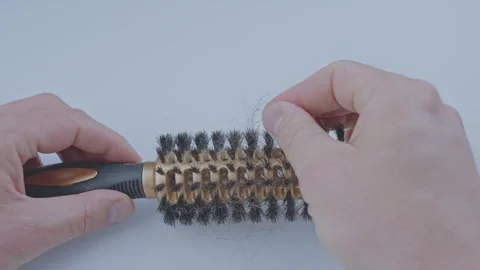 Man hand removing dark tangled hair from hair brush Video stock 247052021