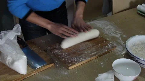 Man hand rolling dough to make steamed buns Stock Footage 47695701