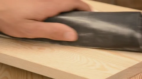 Man hand sanding pine wood Stock Footage 44641691