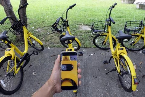 Man hand scanning qr code to unlock bike. Stock Photos