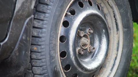 Man hand screwing nuts of wheel tight Stock Footage 32691429