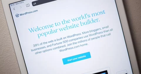 Man hand scrolls down Wordpress.com to browse the website contents Stock Footage 148318712