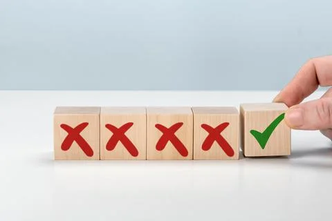Man Hand selects checkbox with green checkmark from row of multiple boxes wit Stock Photos