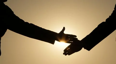 Man hand shake male hand with bright sun gleaming background Stock Footage