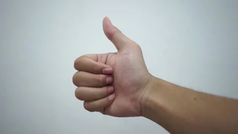 Man hand showing thumb up as a good compliment gesture Stock Footage 228762472