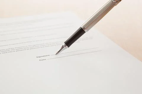 Man hand signing a contract Stock Photos