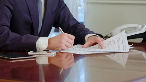 Man hand signs a paper document with ballpoint pen. Signature is fake 스톡 동영상 73170216