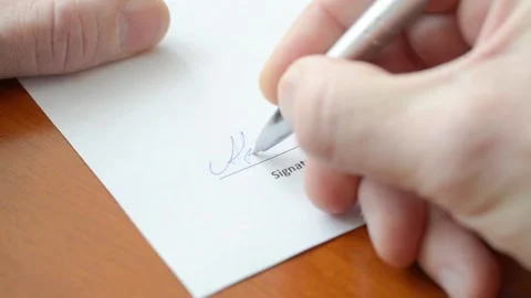 Man hand signs a paper document. Signature is fake. Stock Footage 148823740