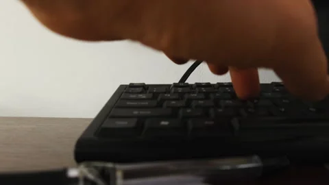 Man hand silhouette typing on computer keyboard at table closeup Stock Footage 304398778