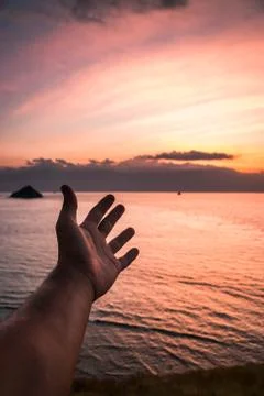 Man hand with sky background. Stock Photos