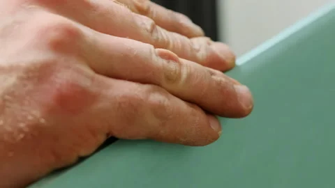 Man hand smoothly runs on corner edge of plasterboard panel Stock Footage 304407000