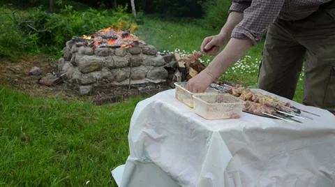 Man hand strung small pieces raw meat on metal skewer Stock Footage 33071671