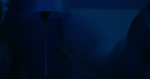 Man hand switch off night light before sweet dreams Stock Footage 228469044