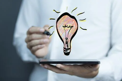 Man hand tablet with light bulb in screen Stock Photos