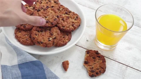 Man hand take chocolate cookie from plate Stock Footage 113755766