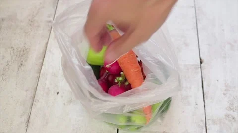 Man hand take fresh vegetables from plastic bag Stock Footage 190769877