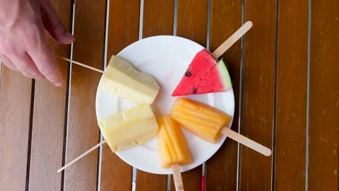 Man hand take a refreshing fruit sticks with pineapple, healthy summer diet Stock Footage 236755465