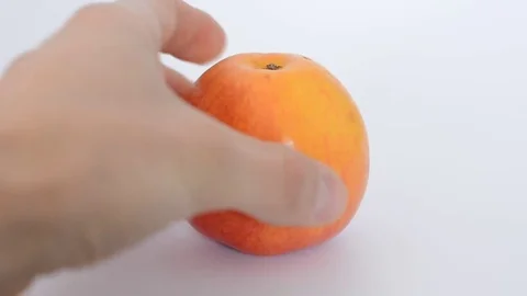 Man hand takes and put back red apple on white backround. Stock Footage 74070206