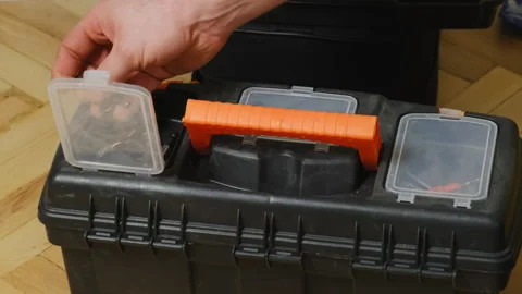 Man hand takes screw from toolbox kit cell placed on floor Stock-Footage 304397729