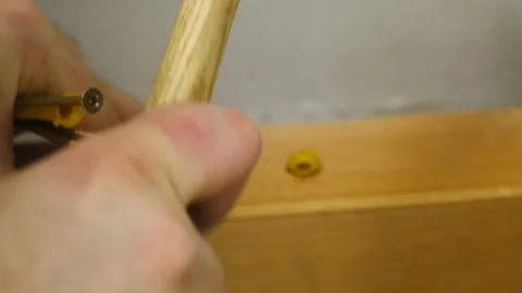 Man hand taps with hammer installing plastic wall anchor Stock Footage 304403683
