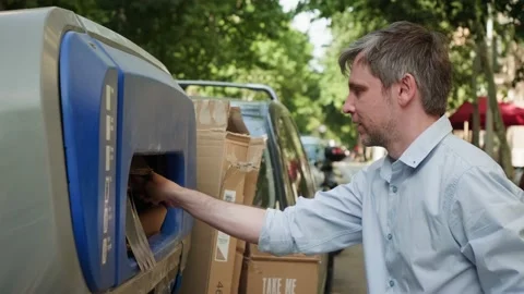Man hand throwing empty paper garbage, recycling of carton delivery boxes in Stock Footage 231353648