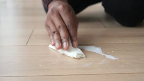Man hand with tissue wipe the floor with tissue. cleaning milk spill Stock Footage 271720536