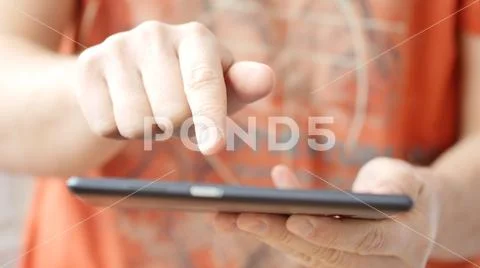 Man hand touching screen on modern digital tablet pc. Stock Photos