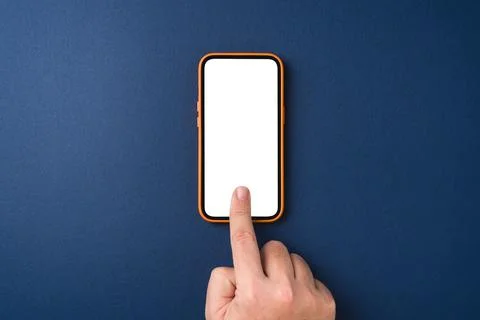 Man hand touching screen of smartphone with index finger on blue background Stock Photos