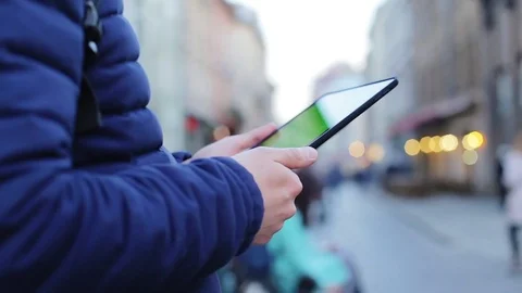 Man hand touching tablet computer surface touchscreen close up green screen Stock Footage 76561868
