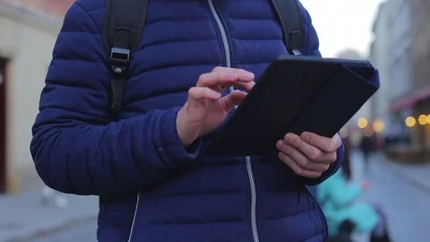 Man hand touching tablet computer surface touchscreen on street in London Stock Footage 76562922