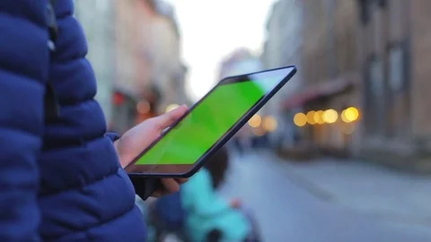 Man hand touching tablet computer surface touch screen on street in city. 1080p Stock Footage 76563140