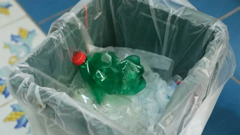 Man hand trash used plastic bottle on separate garbage collection bin,recycle Stock Footage